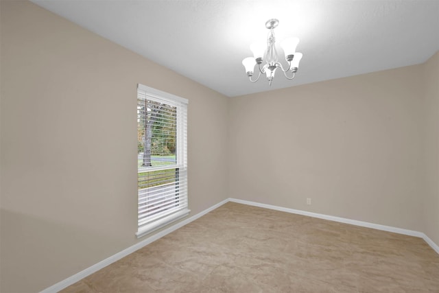 unfurnished room featuring a notable chandelier