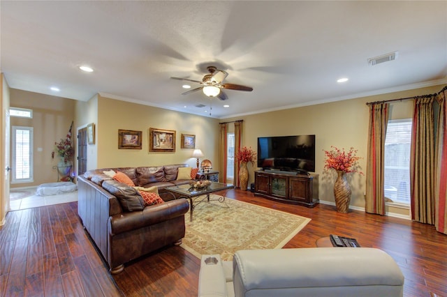 living room featuring dark hardwood / wood-style floors, ceiling fan, and crown molding