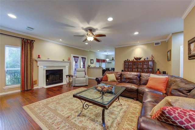 living room with crown molding, ceiling fan, and hardwood / wood-style flooring