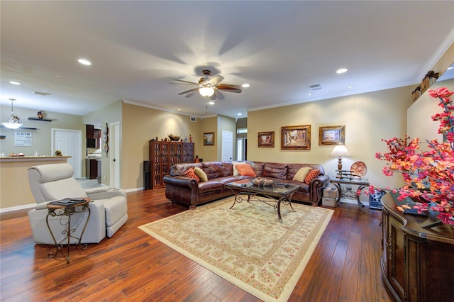 living room featuring ornamental molding, ceiling fan, and dark wood-type flooring