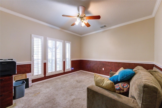 living area featuring light carpet, ceiling fan, a textured ceiling, and ornamental molding