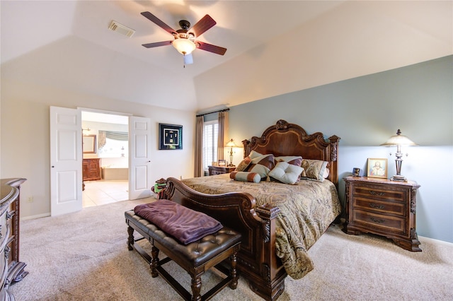 carpeted bedroom with connected bathroom, vaulted ceiling, and ceiling fan