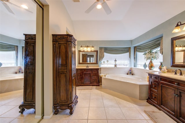 bathroom featuring tile patterned flooring, vanity, lofted ceiling, and tiled tub