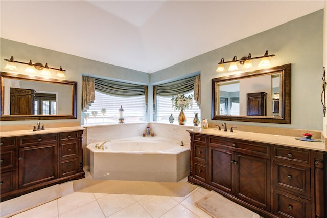 bathroom with tile patterned floors, plenty of natural light, lofted ceiling, and a tub