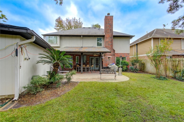 back of property featuring a yard and a patio