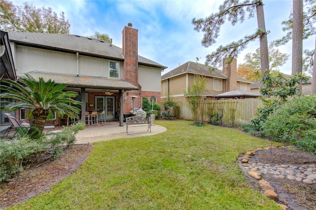 view of yard with french doors and a patio