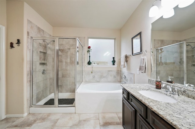 bathroom with vanity and separate shower and tub