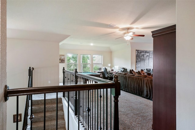 interior space with carpet floors and ceiling fan