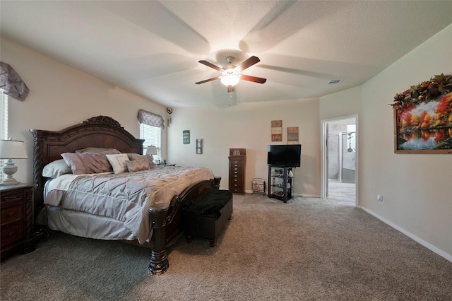 bedroom with ceiling fan, carpet floors, and connected bathroom