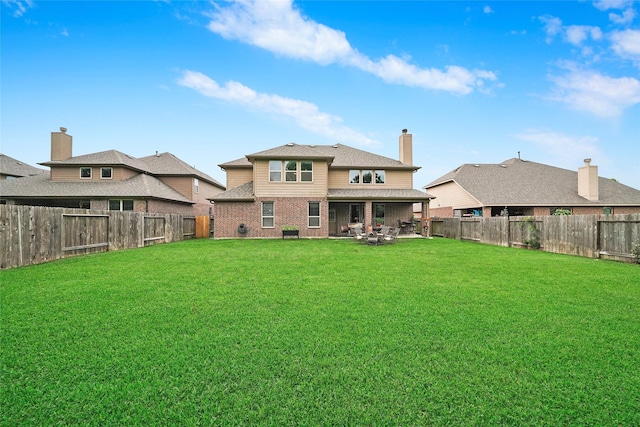 back of house featuring a yard