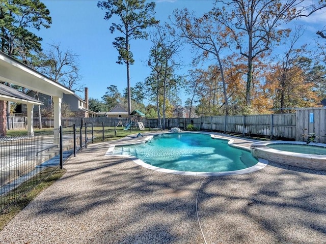 view of swimming pool featuring an in ground hot tub and a patio area