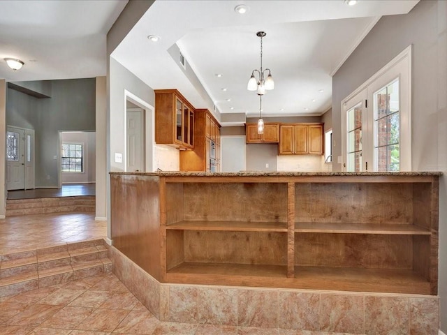 502 Crown Colony Dr, Lufkin, TX 75901 - kitchen with open shelves, brown cabinets, glass insert cabinets, light stone countertops, and pendant lighting