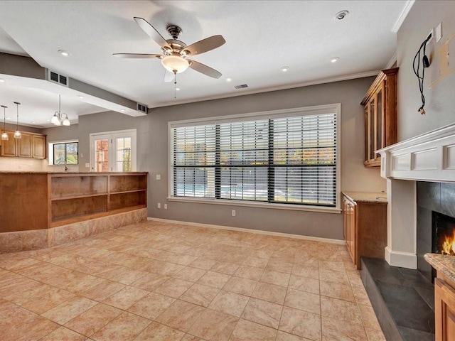 502 Crown Colony Dr, Lufkin, TX 75901 - unfurnished living room featuring ceiling fan, a tiled fireplace, baseboards, ornamental molding, and recessed lighting