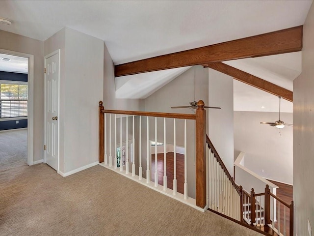 hall with light carpet, high vaulted ceiling, and beamed ceiling