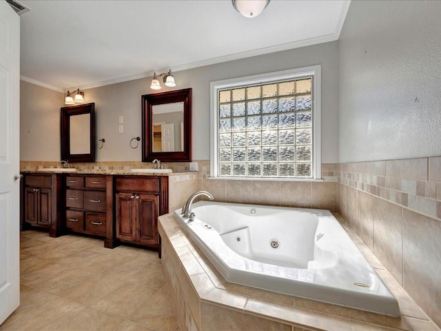 bathroom with tile patterned flooring, vanity, a relaxing tiled tub, and crown molding