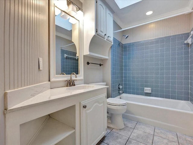 full bathroom featuring vanity, tiled shower / bath combo, crown molding, tile patterned flooring, and toilet