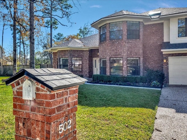 view of front of property with a front lawn and a garage