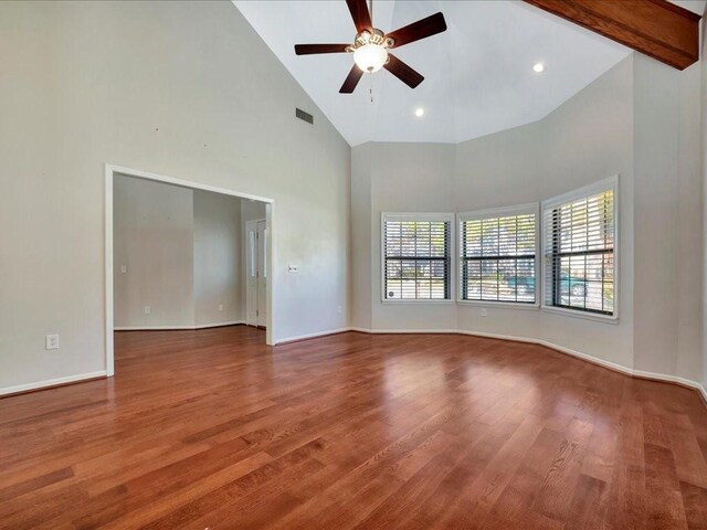 unfurnished room featuring wood-type flooring, high vaulted ceiling, and a wealth of natural light