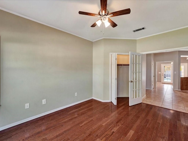 502 Crown Colony Dr, Lufkin, TX 75901 - unfurnished bedroom with french doors, baseboards, wood finished floors, ornamental molding, and ceiling fan