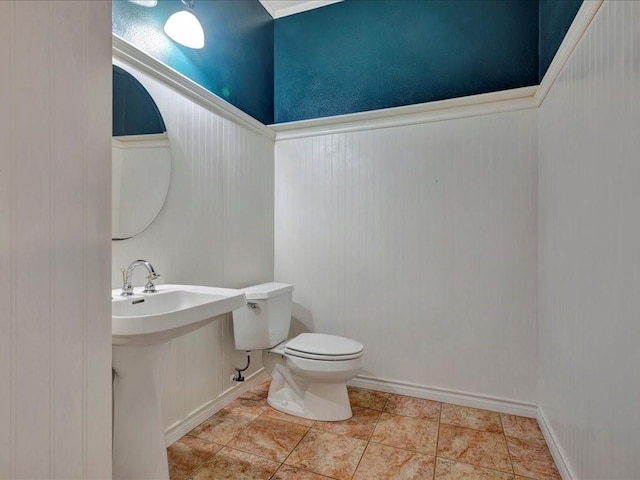 502 Crown Colony Dr, Lufkin, TX 75901 - half bathroom with toilet, a sink, and wainscoting