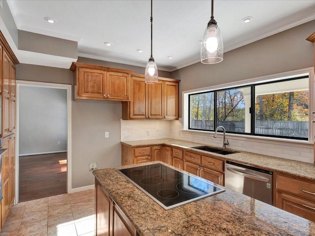 kitchen with stainless steel dishwasher, black electric cooktop, sink, pendant lighting, and light hardwood / wood-style flooring