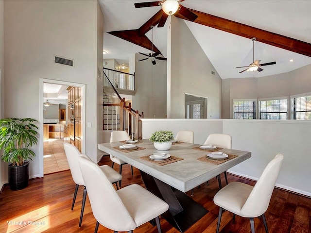 502 Crown Colony Dr, Lufkin, TX 75901 - dining area with a ceiling fan, high vaulted ceiling, stairs, wood finished floors, and beamed ceiling