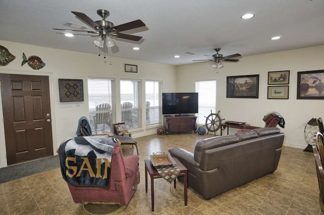 living room featuring visible vents, baseboards, a ceiling fan, and recessed lighting