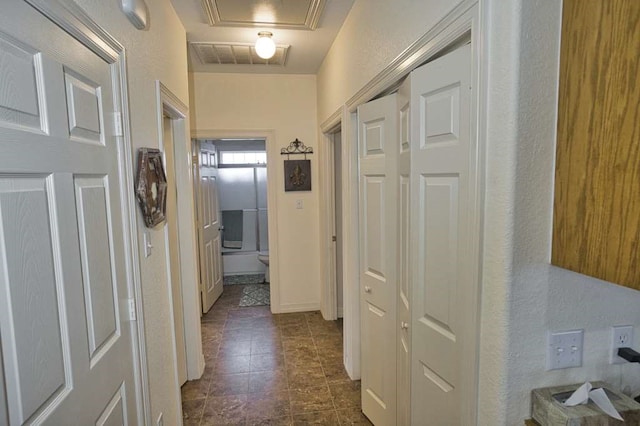 corridor with visible vents and a textured wall