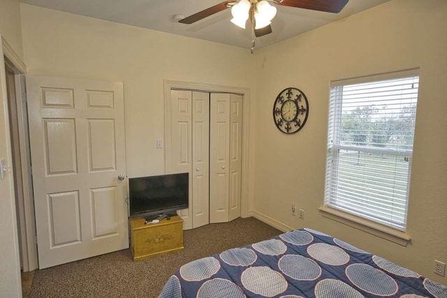 carpeted bedroom with a closet and ceiling fan