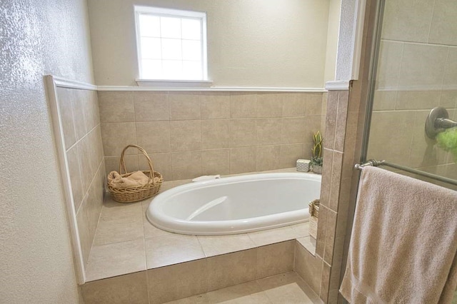 bathroom featuring a shower stall and a bath