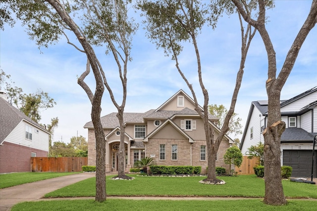 view of front of home with a garage and a front lawn