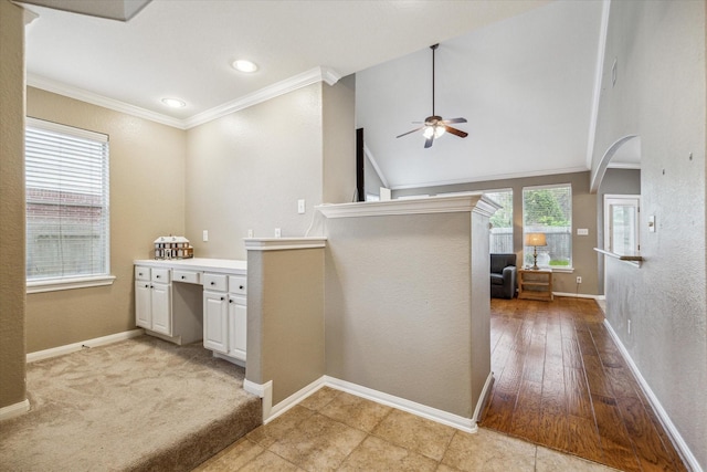 bathroom with ceiling fan, wood-type flooring, lofted ceiling, and ornamental molding