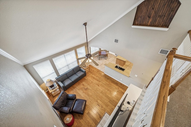 living room with crown molding, high vaulted ceiling, wood-type flooring, and ceiling fan