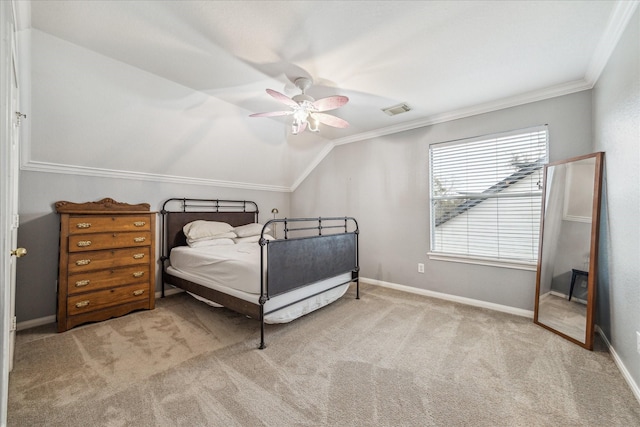 bedroom featuring light carpet, vaulted ceiling, ceiling fan, and crown molding