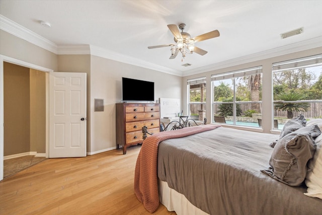 bedroom featuring ceiling fan, light wood-type flooring, and crown molding