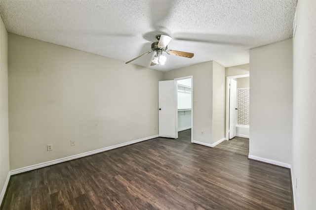 spare room with a textured ceiling, dark hardwood / wood-style floors, and ceiling fan