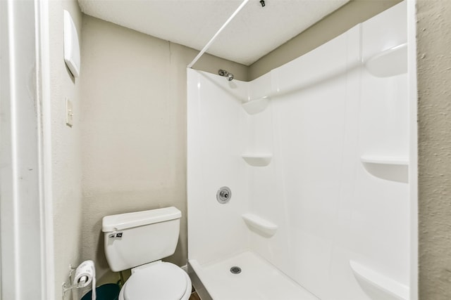 bathroom with a shower and toilet