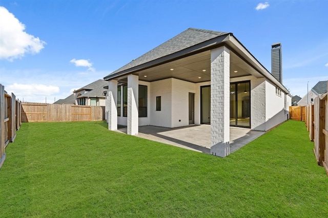 back of house featuring a patio and a lawn