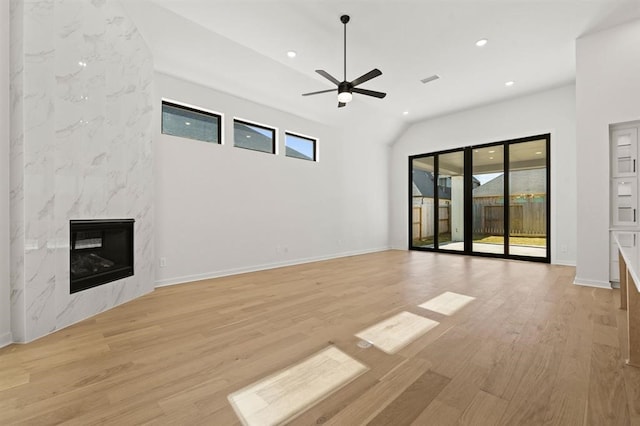 unfurnished living room featuring light hardwood / wood-style flooring, a fireplace, and ceiling fan