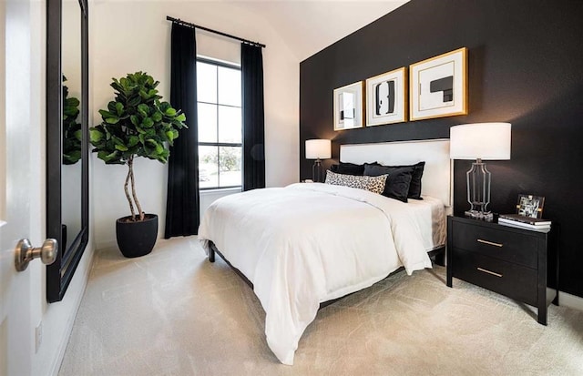 carpeted bedroom with lofted ceiling