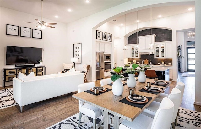 dining area with ceiling fan, sink, and hardwood / wood-style flooring