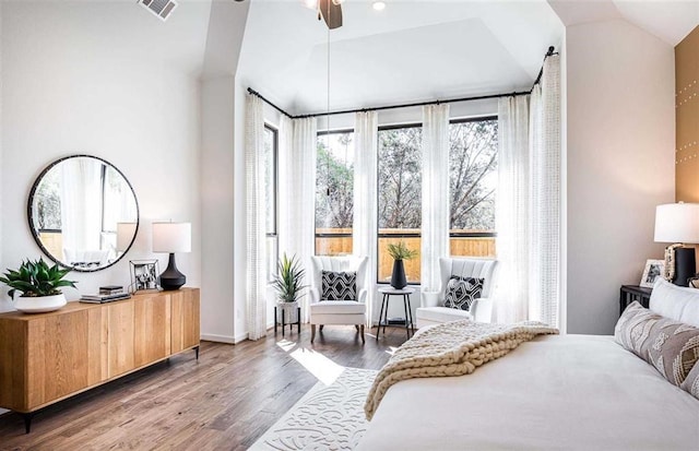 bedroom with ceiling fan, lofted ceiling, and wood-type flooring