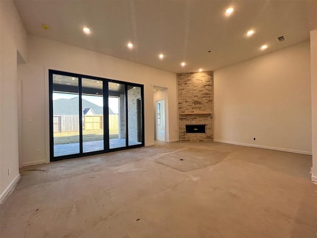 unfurnished living room with a stone fireplace