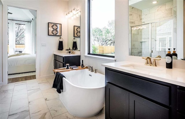 bathroom with vanity, plenty of natural light, and shower with separate bathtub