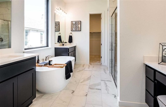 bathroom featuring shower with separate bathtub and vanity