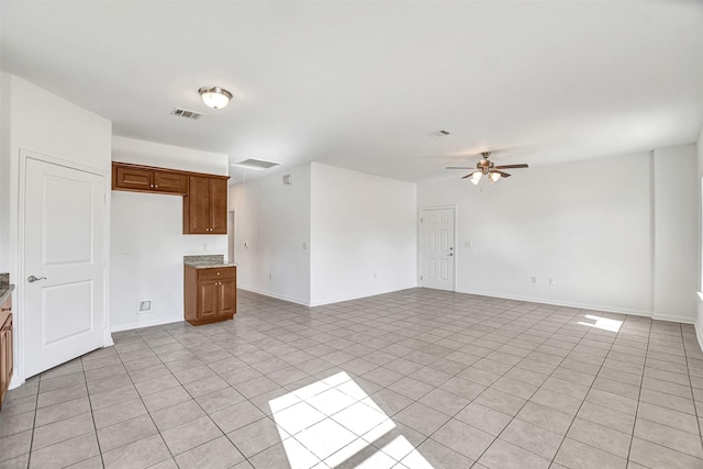 interior space featuring light tile patterned floors and ceiling fan