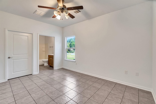 unfurnished bedroom featuring ceiling fan, light tile patterned floors, and connected bathroom