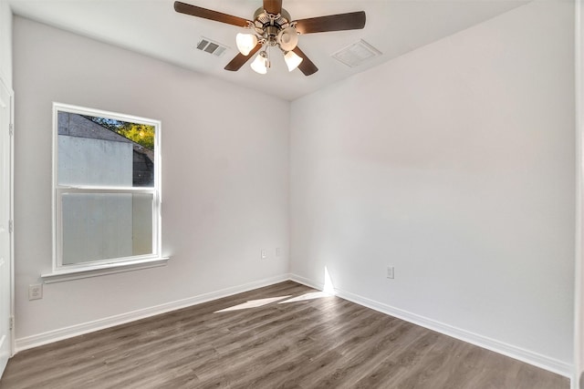 empty room with ceiling fan and dark wood-type flooring