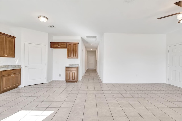 kitchen with ceiling fan and light tile patterned flooring