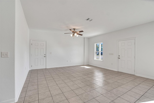 tiled empty room with ceiling fan